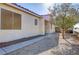 Gravel pathway and small tree beside the house at 7909 Dutch Canyon Ct, Las Vegas, NV 89131