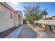 Landscaped yard with pathway and trees alongside the house at 7909 Dutch Canyon Ct, Las Vegas, NV 89131