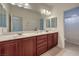 Bathroom with double sinks and light wood cabinets at 7923 Sleeping Lily Dr, Las Vegas, NV 89178