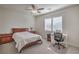 Comfortable bedroom with a queen-size bed and a home office at 7923 Sleeping Lily Dr, Las Vegas, NV 89178