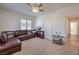 Bright bedroom featuring a leather sectional and access to a hallway at 7923 Sleeping Lily Dr, Las Vegas, NV 89178