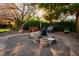 Landscaped backyard patio with seating and fire pit area at 8365 Hauck St, Las Vegas, NV 89139