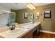 Bathroom featuring double sinks, tiled countertop, and a glass shower at 8365 Hauck St, Las Vegas, NV 89139