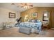 Cozy bedroom with a ceiling fan, carpeted floor, natural light, and an accent wall at 8365 Hauck St, Las Vegas, NV 89139