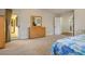 Bright bedroom featuring light-colored walls, carpeted floors, and a glass door to the outdoors at 8365 Hauck St, Las Vegas, NV 89139