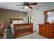 Comfortable bedroom with a ceiling fan, a dresser with a mirror, and a neutral color scheme at 8365 Hauck St, Las Vegas, NV 89139