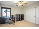 Bright bedroom featuring a workspace, ample closet space, and a ceiling fan at 8365 Hauck St, Las Vegas, NV 89139