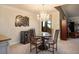 Cozy dining area with a glass table, chandelier, and a built-in wine fridge at 8365 Hauck St, Las Vegas, NV 89139