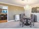 Elegant dining area featuring a chandelier, seating for four, and access to the kitchen at 8365 Hauck St, Las Vegas, NV 89139