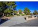 Well-maintained single-story home with a long driveway and mature trees at 8365 Hauck St, Las Vegas, NV 89139