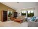 Comfortable living room featuring a sectional sofa, natural light, and built-in bookshelves at 8365 Hauck St, Las Vegas, NV 89139