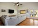 Bright living room featuring a ceiling fan, hardwood floors, and a view of the pool area at 8365 Hauck St, Las Vegas, NV 89139