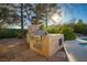 Outdoor kitchen featuring stone construction, built in grill, and ample counter space for entertaining at 8365 Hauck St, Las Vegas, NV 89139