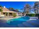 Large kidney shaped pool with a spacious deck and solar panels on the roof at 8365 Hauck St, Las Vegas, NV 89139