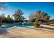 Inviting pool and spa with a large deck and mature trees surrounding at 8365 Hauck St, Las Vegas, NV 89139