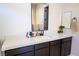 Bathroom with a single vanity, quartz countertop, and dark brown cabinets at 862 Silverton Springs St, Henderson, NV 89011