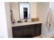 Clean bathroom with single vanity, quartz countertop, and dark brown cabinets at 862 Silverton Springs St, Henderson, NV 89011