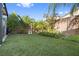 Lush backyard with artificial grass, mature trees, and manicured garden beds offer a private retreat at 8620 Grove Mill Ct, Las Vegas, NV 89139