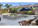 Inviting backyard with pool, water feature, and lounge chairs, perfect for outdoor relaxation and entertainment at 8620 Grove Mill Ct, Las Vegas, NV 89139