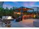 Entertainer's backyard with a fire pit, built-in barbecue, pergola, outdoor seating, and lush landscaping at 8620 Grove Mill Ct, Las Vegas, NV 89139