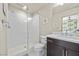 Modern bathroom with a glass shower, white vanity, and toilet at 8620 Grove Mill Ct, Las Vegas, NV 89139