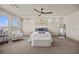 Bright bedroom with large windows, ceiling fan, and stylish furnishings at 8620 Grove Mill Ct, Las Vegas, NV 89139
