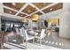 Open-concept dining area featuring a coffered ceiling, modern lighting, and elegant furnishings at 8620 Grove Mill Ct, Las Vegas, NV 89139