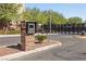 Gated community entrance features a brick pillar with a secure entry system and desert landscaping at 8620 Grove Mill Ct, Las Vegas, NV 89139