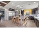 Kitchen with large island, dark cabinets, and yellow wall at 8620 Grove Mill Ct, Las Vegas, NV 89139