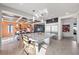 Bright, open kitchen with a large island, stainless steel appliances, and stylish dining area at 8620 Grove Mill Ct, Las Vegas, NV 89139
