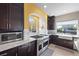 Well-lit kitchen showcases stainless steel range, white countertops and backsplash, with dark cabinetry at 8620 Grove Mill Ct, Las Vegas, NV 89139