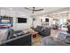Spacious living room with modern furniture, large TV, open to the dining area and kitchen at 8620 Grove Mill Ct, Las Vegas, NV 89139