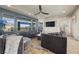 Comfortable living room featuring a modern ceiling fan, large windows, and two sofas at 8620 Grove Mill Ct, Las Vegas, NV 89139