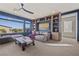 Stylish living room featuring a large window with a scenic view, custom bookshelves, and comfortable seating at 8620 Grove Mill Ct, Las Vegas, NV 89139