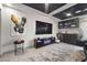 Modern living room featuring a large TV, sleek entertainment center, and stylish decor at 8620 Grove Mill Ct, Las Vegas, NV 89139