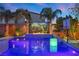 Inviting pool featuring lush landscaping, waterfall feature, and ambient lighting for a serene outdoor experience at 8620 Grove Mill Ct, Las Vegas, NV 89139