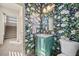 Charming powder room with floral wallpaper, vintage-style vanity, and ample natural light at 8620 Grove Mill Ct, Las Vegas, NV 89139