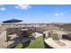 Entertaining rooftop area featuring dining set, lounge seating, artificial turf and panoramic views at 8620 Grove Mill Ct, Las Vegas, NV 89139