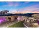 Relaxing rooftop patio with an umbrella, seating, and sunset views at 8620 Grove Mill Ct, Las Vegas, NV 89139
