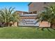 Rainbow Crossing Estates signage is displayed with lush landscaping and palm trees at 8620 Grove Mill Ct, Las Vegas, NV 89139