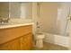 Clean bathroom with a tub and wooden vanity at 8760 Harvest Valley Ave, Las Vegas, NV 89129