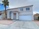 Two-story house with attached garage and landscaping at 8760 Harvest Valley Ave, Las Vegas, NV 89129