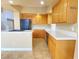 Eat-in kitchen with oak cabinets, an island, and a breakfast bar at 8760 Harvest Valley Ave, Las Vegas, NV 89129