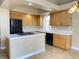 Bright kitchen with oak cabinets, island, and stainless steel appliances at 8760 Harvest Valley Ave, Las Vegas, NV 89129