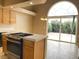 Kitchen with island and sliding glass door to backyard at 8760 Harvest Valley Ave, Las Vegas, NV 89129