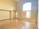 Bright living room with hardwood floors and large window at 8760 Harvest Valley Ave, Las Vegas, NV 89129