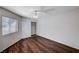 Bright bedroom with wood-look floors, ceiling fan, and sliding closet doors at 9320 Quail Ridge Dr, Las Vegas, NV 89134