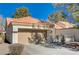 Single-story home with a tan garage door and Spanish tile roof at 9320 Quail Ridge Dr, Las Vegas, NV 89134