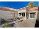 Backyard patio with gravel and a walkway leading to the house at 9320 Quail Ridge Dr, Las Vegas, NV 89134