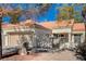 Single-story home with a tan garage door and Spanish tile roof at 9320 Quail Ridge Dr, Las Vegas, NV 89134